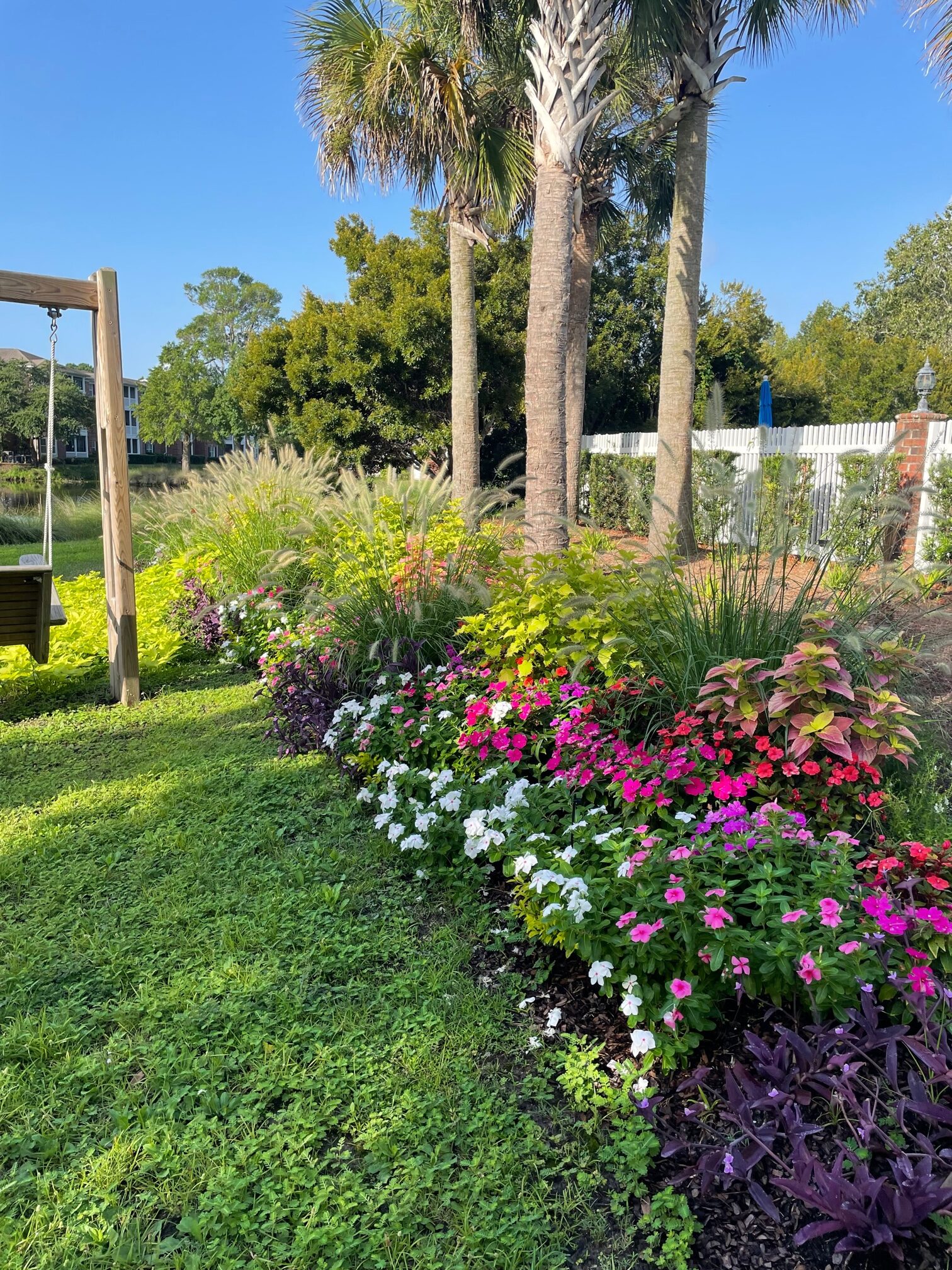 Pink and white flower bed along a customers property line.